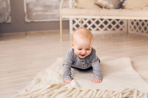 Little baby boy crawling on the floor at home - Stock Photo - Images