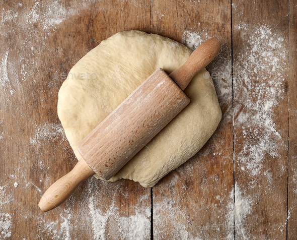 fresh raw dough and rolling pin Stock Photo by magone | PhotoDune