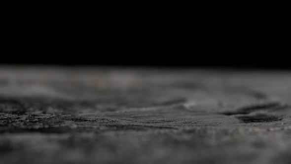 Nuts Fall on the Table Black Background by elisichenko 