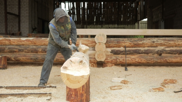 Construction Worker Cuts a Groove in the Tree for a Future Home. Protective Mask and Headphone on