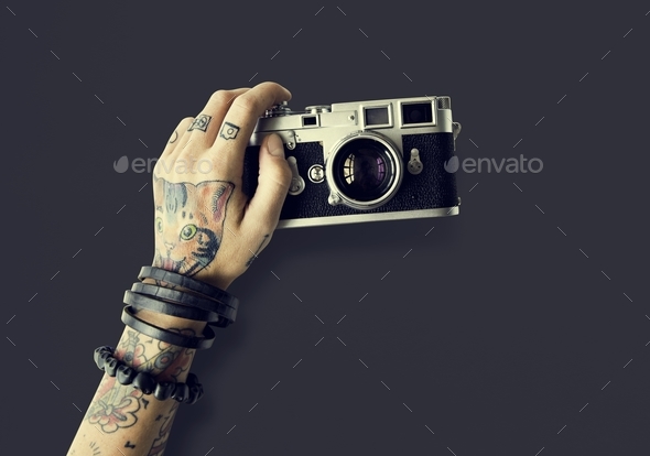 Tattoo on Arm Holding Camera · Free Stock Photo
