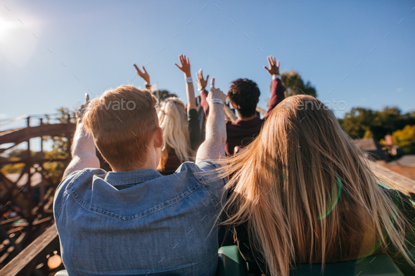 Young people on a thrilling roller coaster ride - Stock Photo - Images