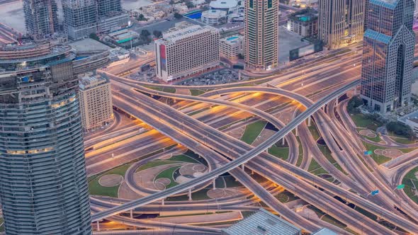 Aerial View of Highway Interchange in Dubai Downtown Night to Day Timelapse alt