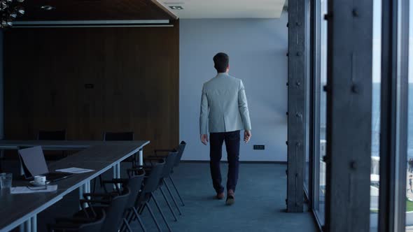 Executive Man Walking Alone in Modern Company Office alt