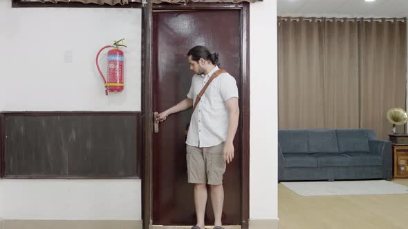 Indian man enters the house alt