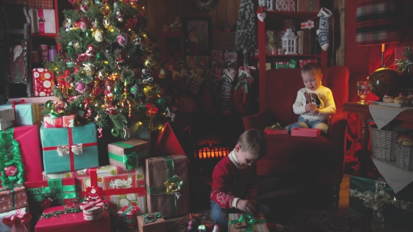 Children Near Christmas Tree with Gifts To Open Their Christmas Gifts