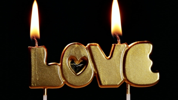 Cake with the Word Love and Burning Candles