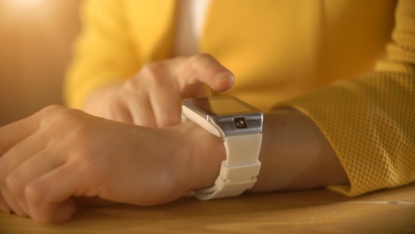 Woman's Hand Touching the Screen of a Smart Watch