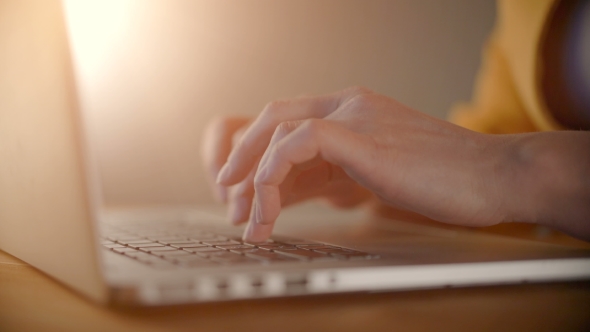 Woman Hands Typing on Laptop on Wooden Table