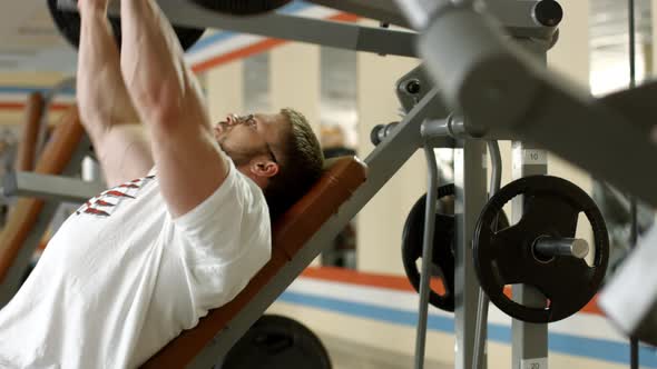 Athlete Working Out in Gym. alt