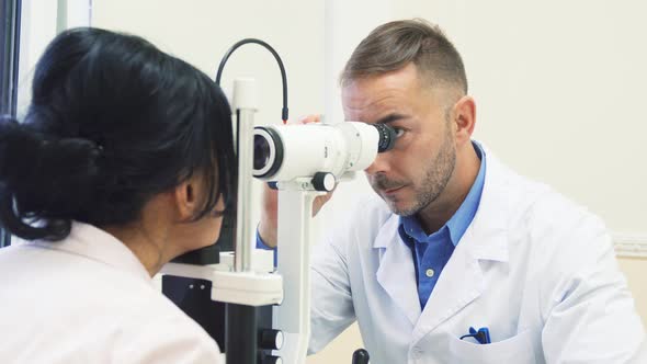 Attentive Ophthalmologist Examines the Eyes of His Patient