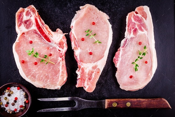 fresh raw meat of pork on a dark background - Stock Photo - Images
