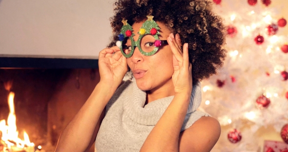 Fun Vivacious Young Woman Celebrating Christmas alt