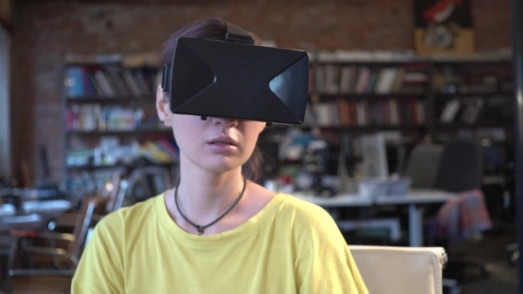 Woman in VR Glasses Looking Up and Touch Objects alt