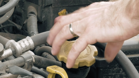 Auto Mechanic Pours Additional Motor Engine Oil