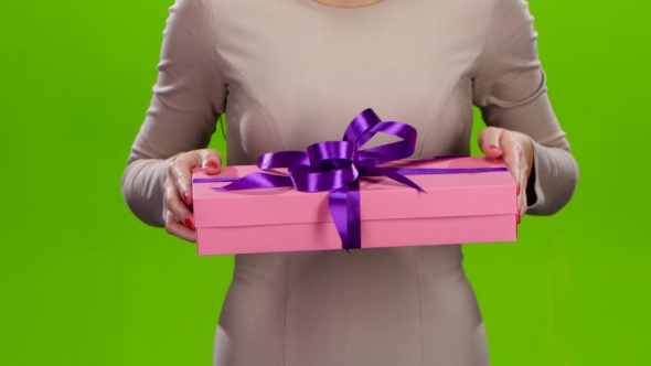 Girl Holding Out a Box with a Gift. alt