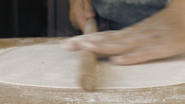 Rolling the Pastry Dough on a Flat Wooden Surface
