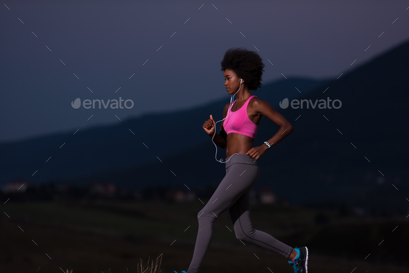 Young African american woman jogging in nature - Stock Photo - Images