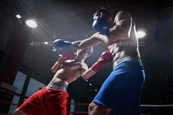 Fighting in boxing ring - Stock Photo - Images