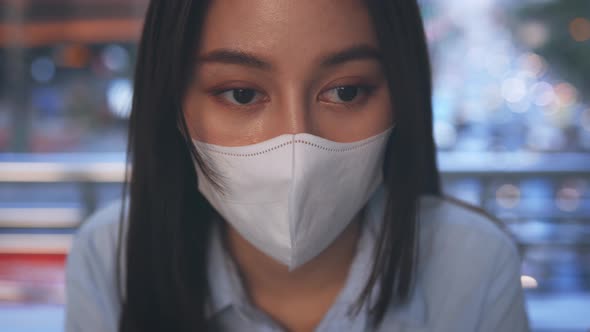 Depressed Woman with Mask Lost Job Sitting with Box of Items alt
