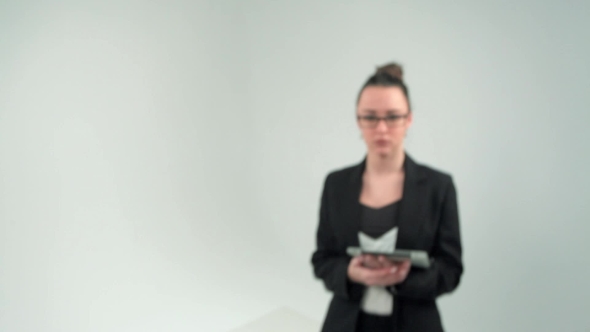 Confident Young Woman in Formalwear Adjusting Her Eyeglasses and Looking at Camera While Standing