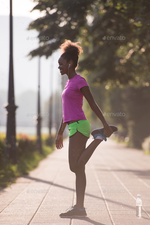 Black woman doing warming up and stretching Stock Photo by dotshock