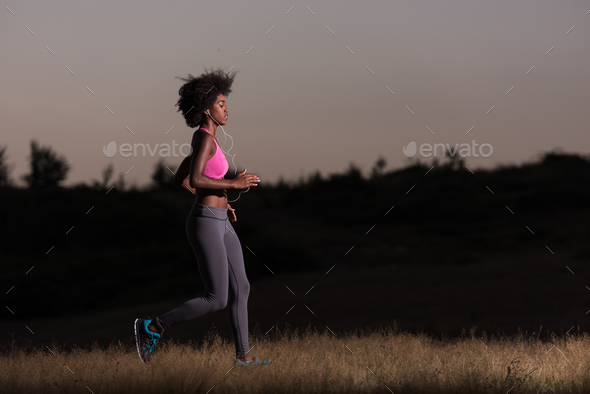 Young African american woman jogging in nature