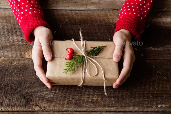 Unrecognizable woman holding Christmas present. Close up. - Stock Photo - Images