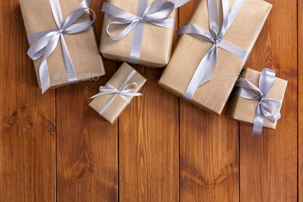 Presents in gift boxes on wood frame background - Stock Photo - Images