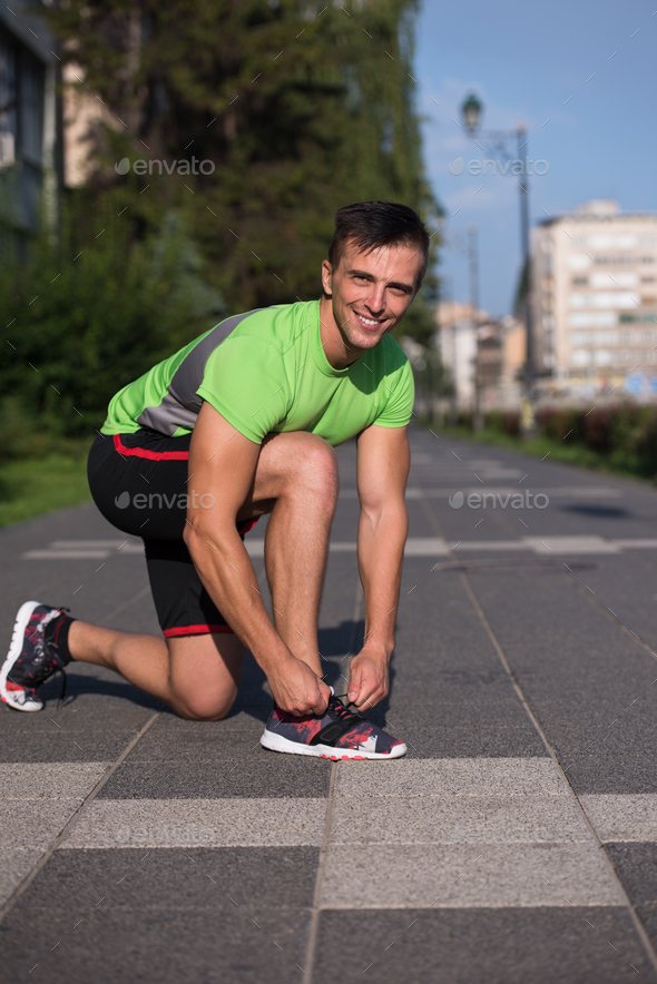 Young athlete, runner tie shoelaces in shoes - Stock Photo - Images