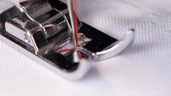 Sewing Machine Sews a White Cloth Black Thread. alt