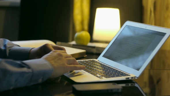 Man in Shirt Works at the Computer at Home