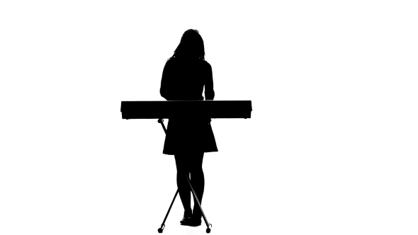 Slender Girl in Musician Plays a Synthesizer alt