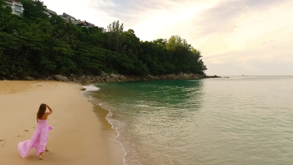 Aerial: Lonely Girl Walks Alone on the Beach. alt