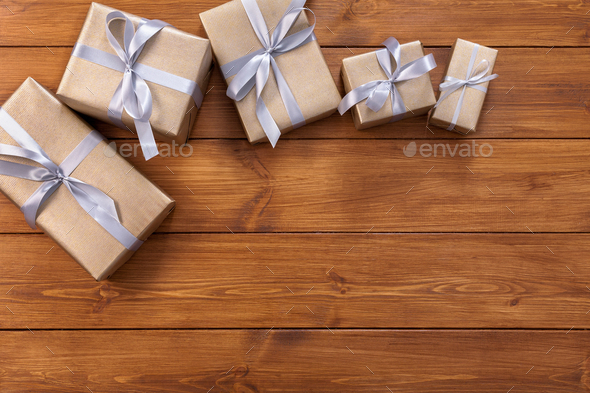 Presents in gift boxes on wood frame background - Stock Photo - Images