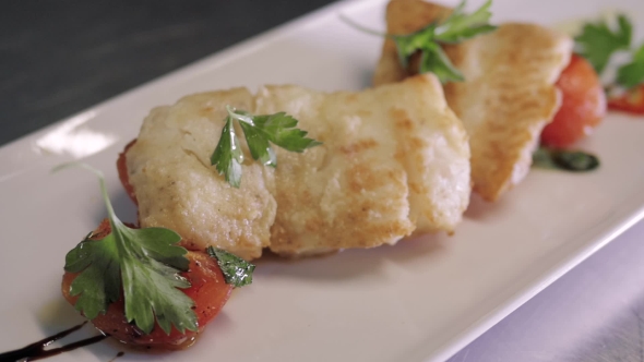 Healthy Food Concept: Chief Serving Hot Baked Fish Piece Over White Plate alt
