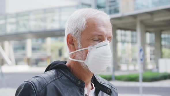 Caucasian man out and about in the street wearing on a face mask against coronavirus alt