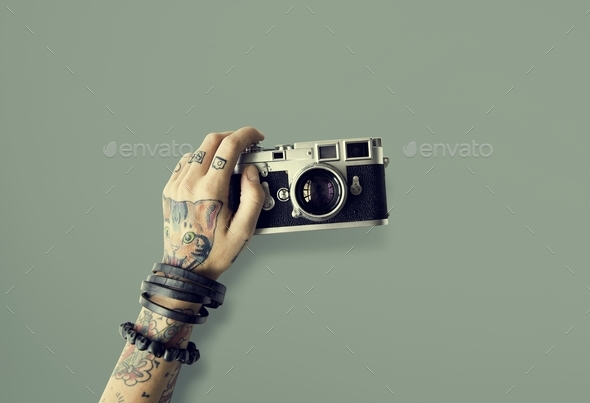 Premium Photo | Hands with tattoo holding a camera