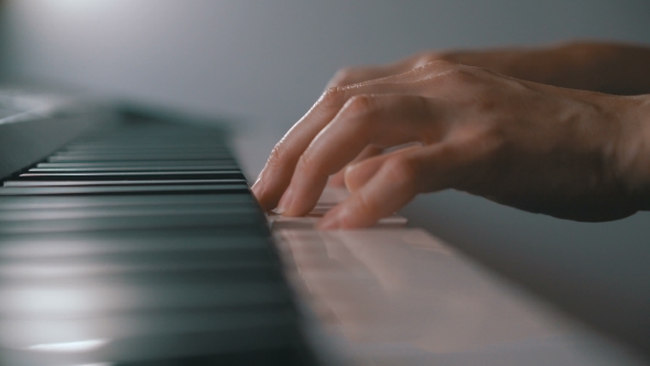 Woman's Hands on the Keyboard of the Piano