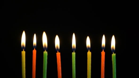 Footage Colorful Burning Candles Set on Black Background. alt