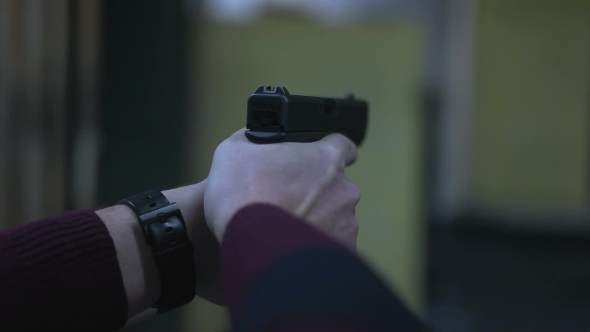 Man Holding a Gun To the Shooting Range