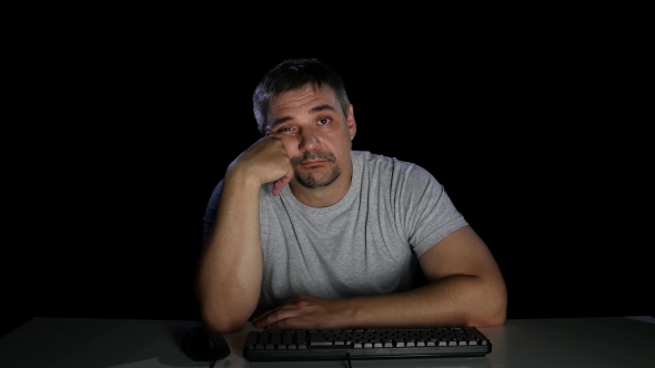 Man with Indifference Looking at a Computer Screen alt