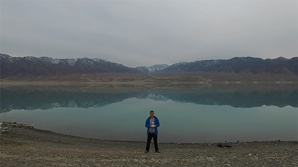 A Man With a Drone on a Mountain Lake.