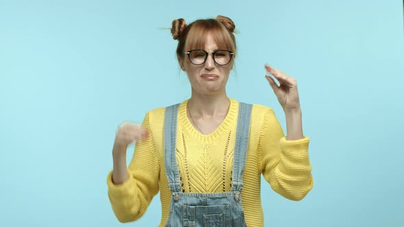 Annoyed Hipster Woman in Glasses and Overalls Mocking Someone Talking Too Much Showing Blah Blah