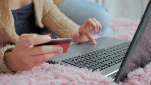 Woman Shopping Online at Laptop with Credit Card