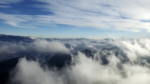 Aerial Drone Flying Over Mountains and Clouds