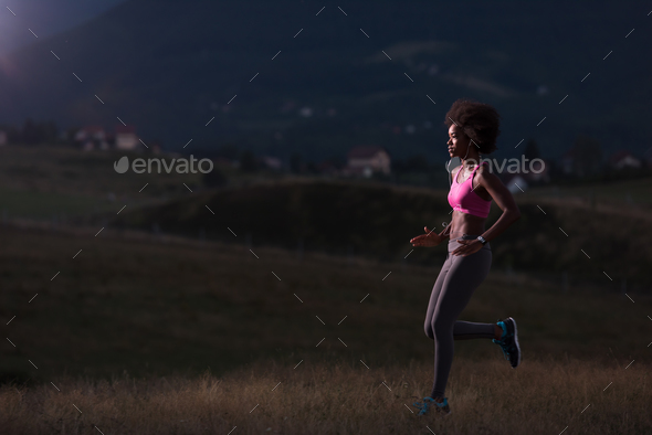 Young African american woman jogging in nature Stock Photo by dotshock
