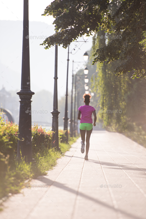 african american woman jogging in the city
