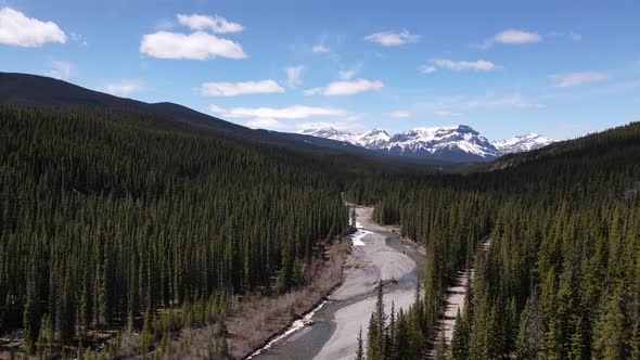 Aerial View Of River Near Crescent Falls Alberta Canada With Snow Top Mountains alt