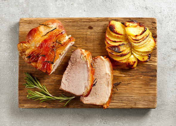 roasted pork on wooden cutting board - Stock Photo - Images